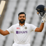 Rohit Sharma raising his bat in celebration after a Test century, wearing the Indian Test cricket jersey, marking a memorable moment in his final red-ball innings.