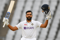 Rohit Sharma raising his bat in celebration after a Test century, wearing the Indian Test cricket jersey, marking a memorable moment in his final red-ball innings.